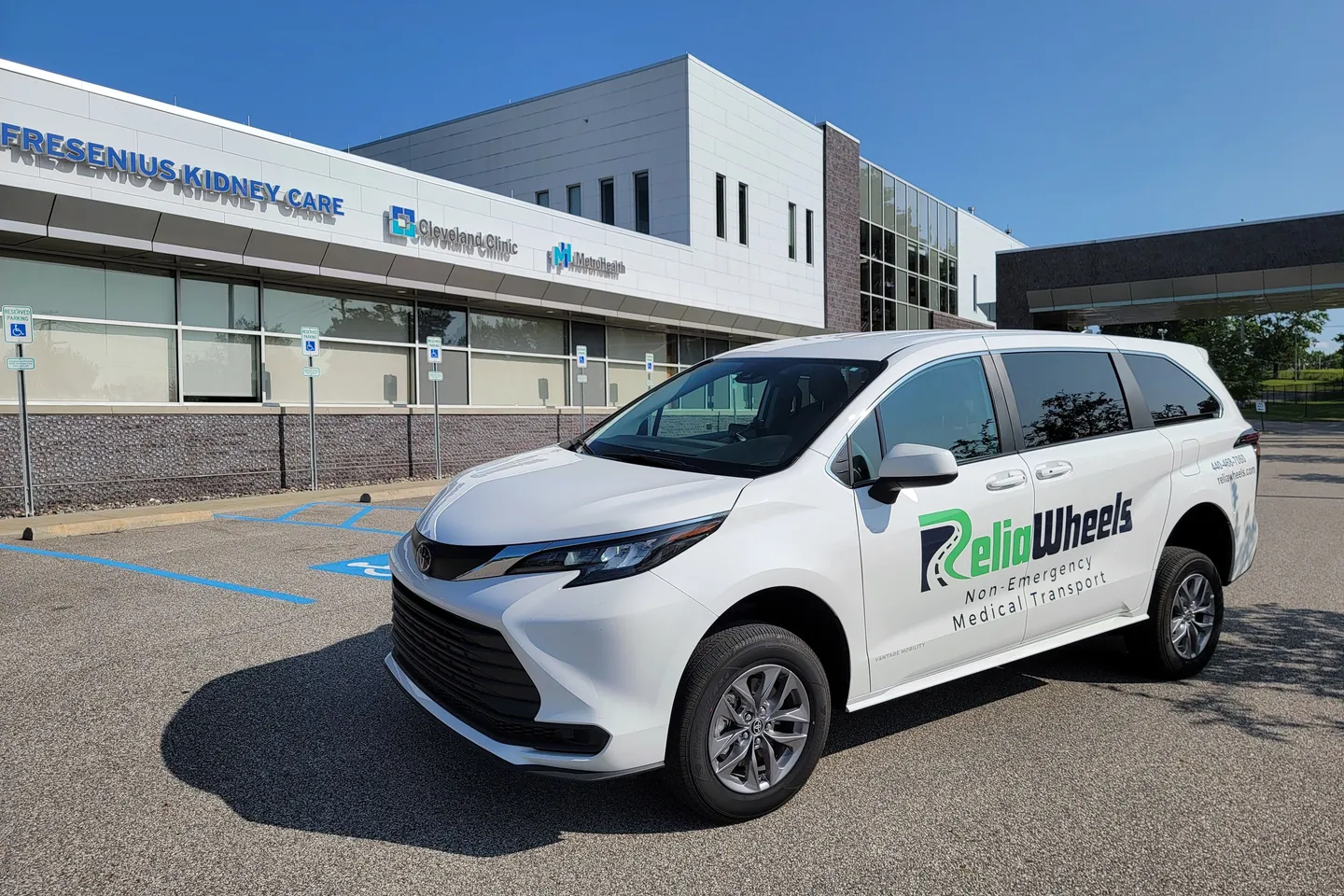 A white ReliaWheels van parked outside a Fresenius Kidney Care dialysis center