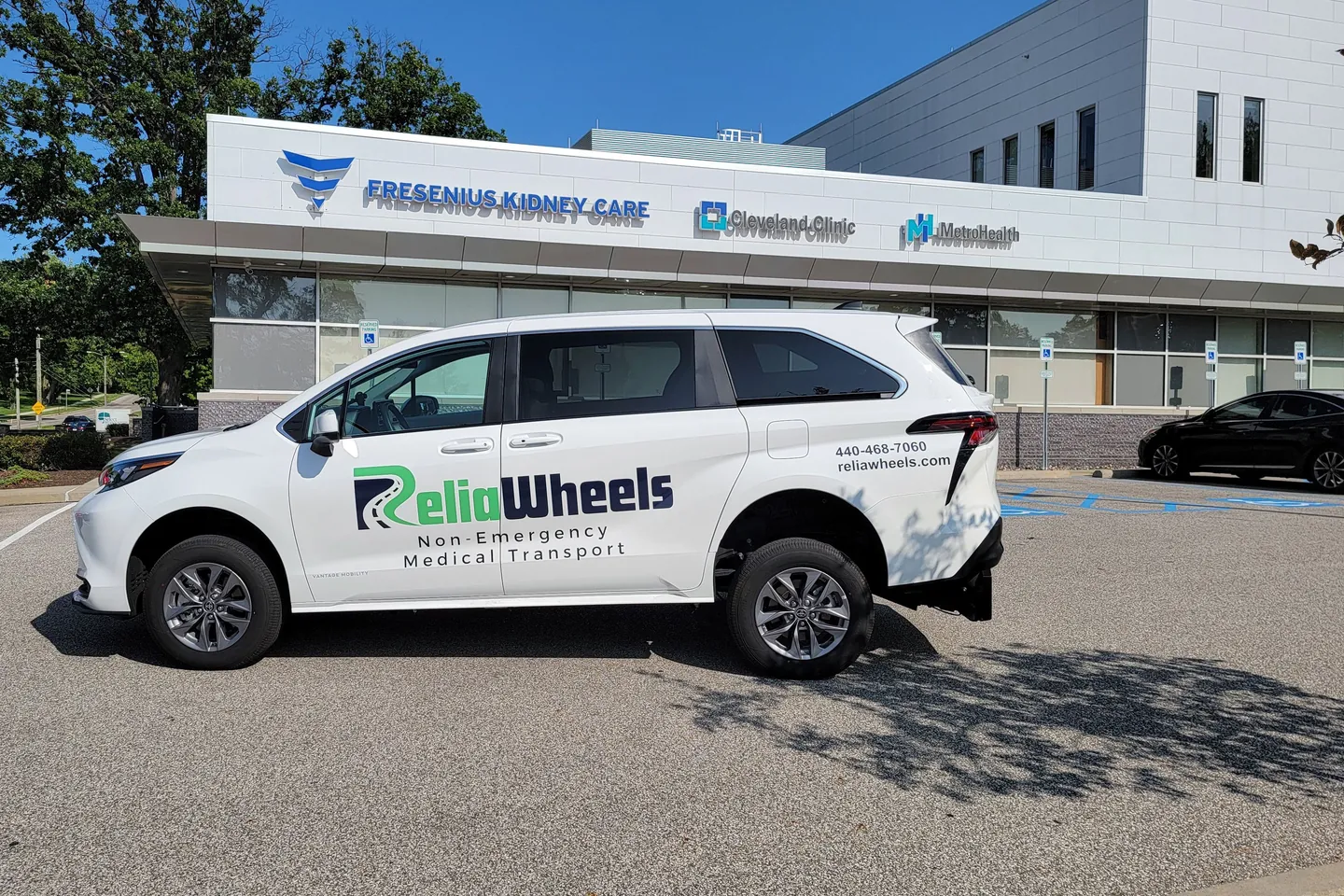 A white ReliaWheels van parked outside a Fresenius Kidney Care dialysis center