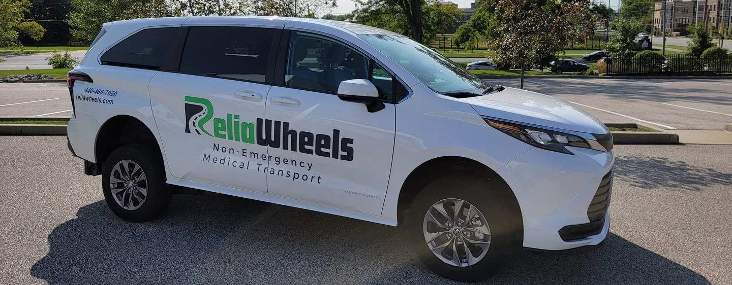 A white ReliaWheels wheelchair-accessible van parked in a sunny lot