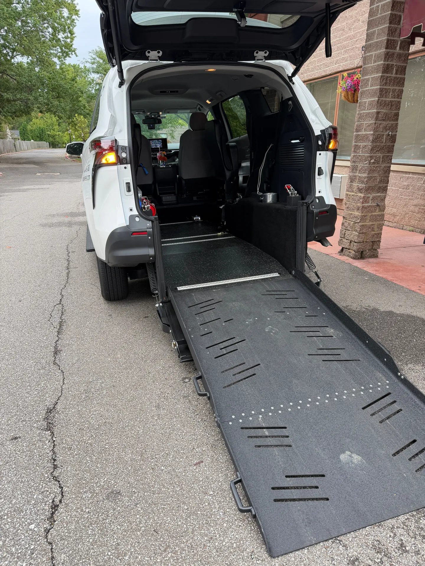 Looking up the lowered wheelchair ramp into the back of a ReliaWheels van