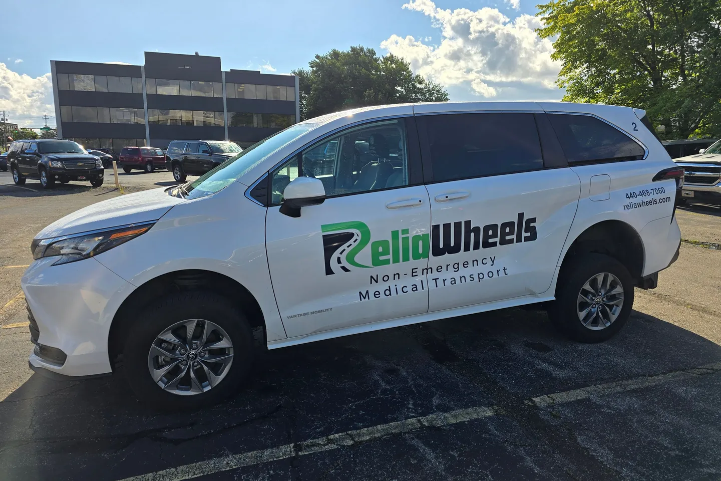A white ReliaWheels wheelchair van parked in a sunny lot